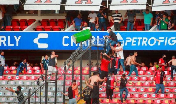"17 reported dead" and 22 injured in brawl between rival fans at Mexican football match