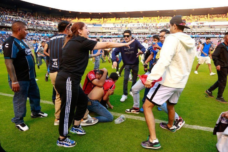"17 reported dead" and 22 injured in brawl between rival fans at Mexican football match