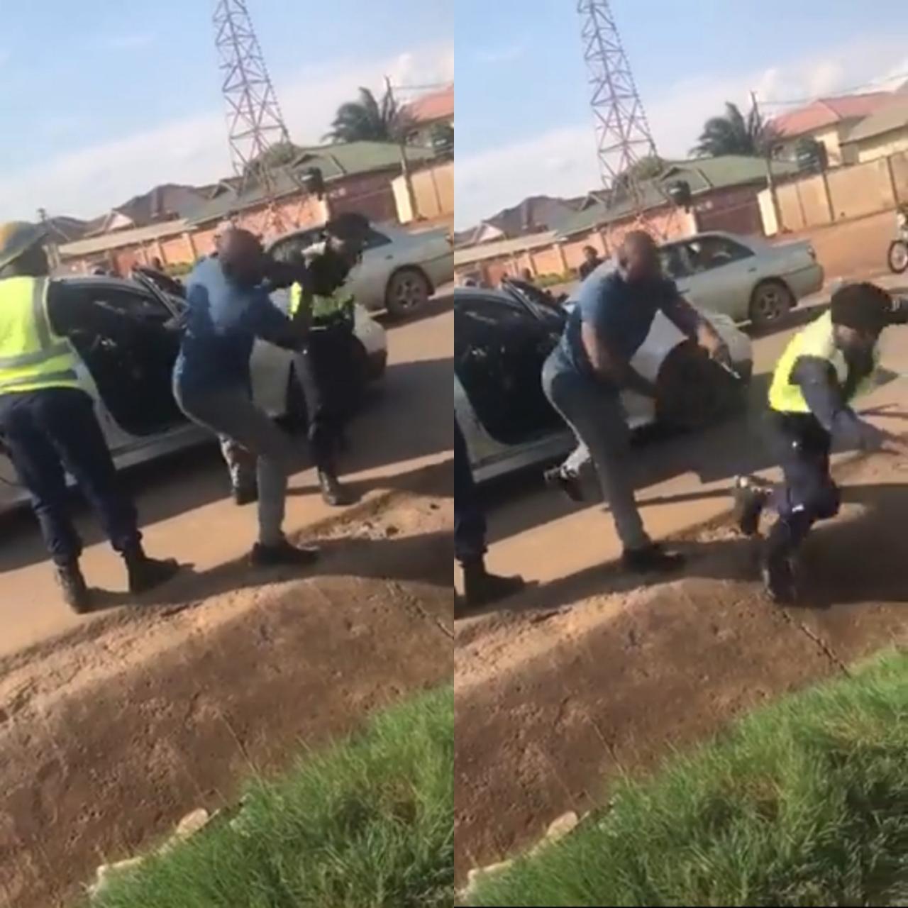 Huge man fights off officers and flings one into gutter after they stopped him and tried to force him out of his car (video)