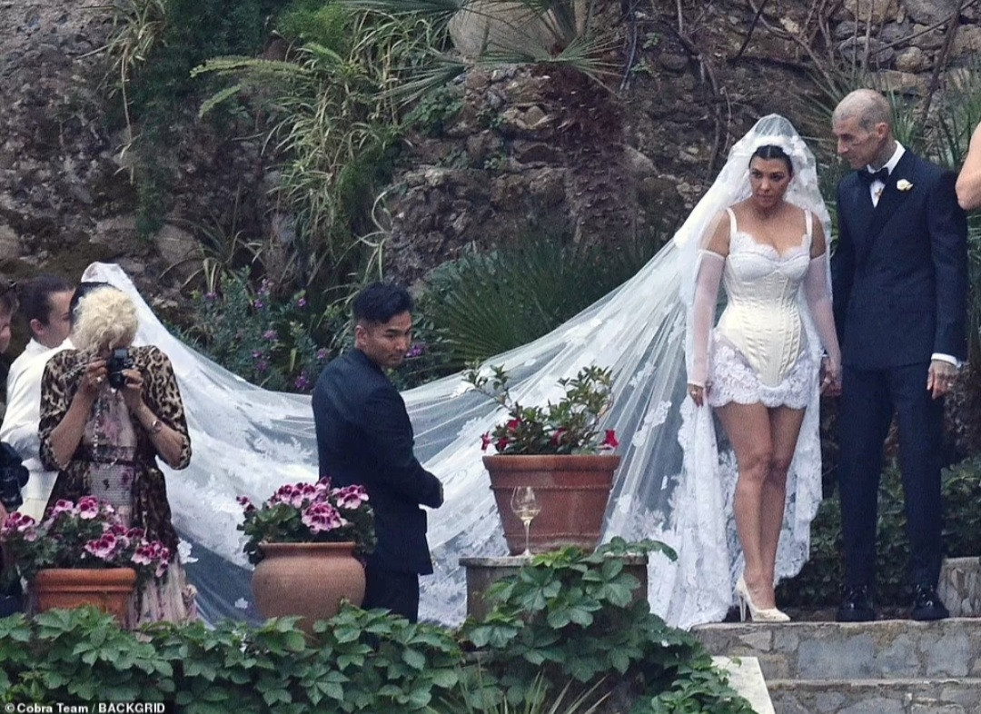 Kourtney Kardashian stuns in a mini dress and a veil with an embroidery of the Virgin Mary as she marries Travis Barker again