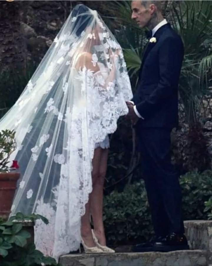 Kourtney Kardashian stuns in a mini dress and a veil with an embroidery of the Virgin Mary as she marries Travis Barker again