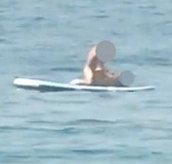 Raunchy couple caught making out on paddleboard in the middle of the ocean (video)