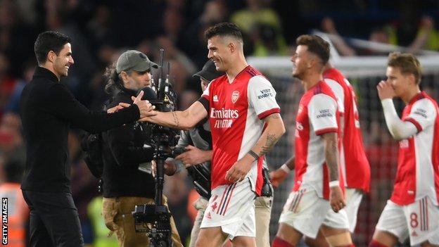 Granit Xhaka (centre) and Mikel Arteta (left).