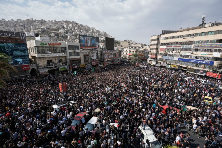 Mourners attend the funeral of Palestinians killed in an overnight Israeli raid, in the occupied West Bank city of Nablus