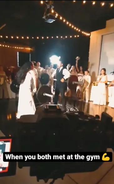 Bride and groom lift weights at their wedding reception (video)