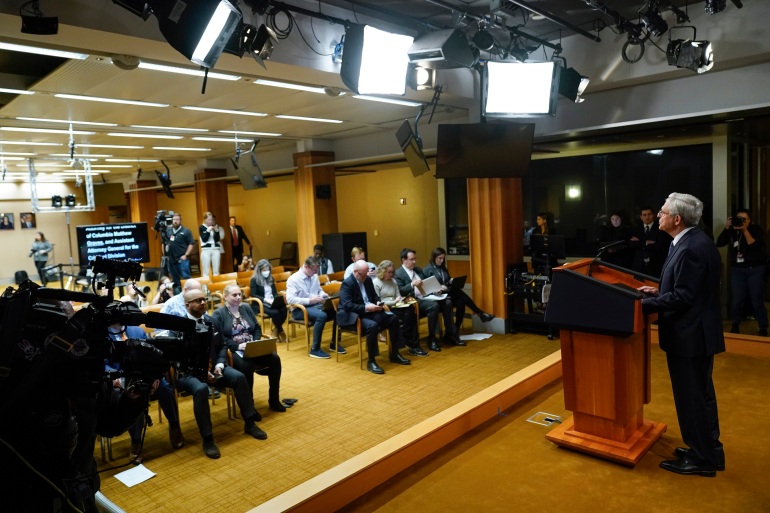 US Attorney General Merrick Garland reads from a teleprompter as he addresses the press on November 18