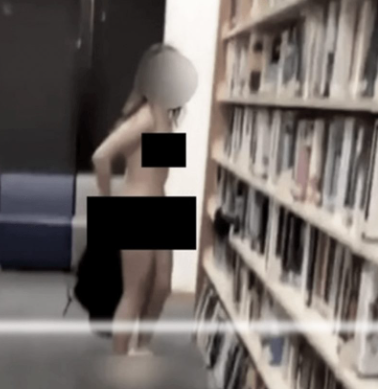 Naked woman filmed browsing library bookshelf