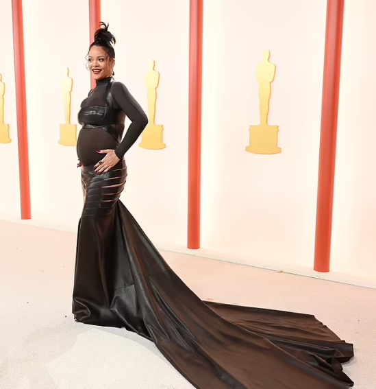Pregnant Rihanna shows off her baby bump in sheer dress on the Oscars 2023 red carpet (video)