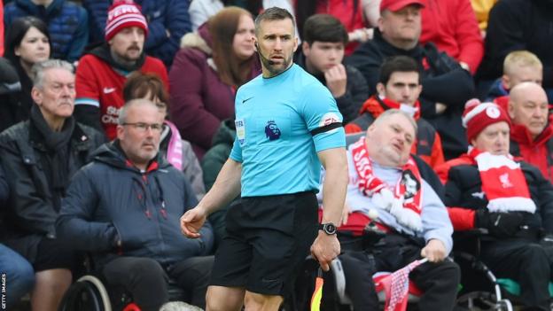 Assistant referee Constantine Hatzidakis in action at Anfield