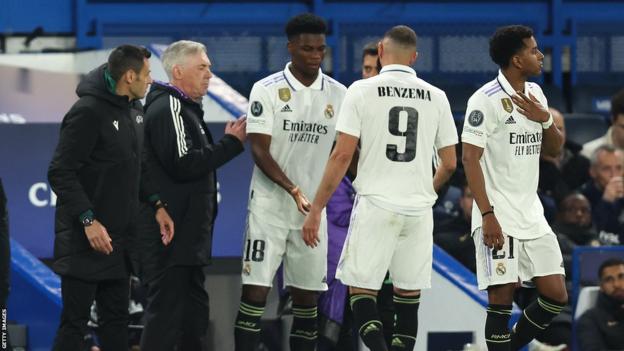 Karim Benzema is taken off the pitch after picking up a knock