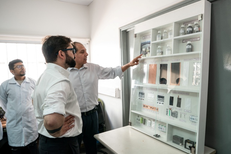 Chile's President Gabriel Boric looks to lithium samples and applications while visiting Universidad de Antofagasta venue, after saying on Thursday he would nationalize the country's lithium industry, in the northern city of Antofagasta, Chile April 21, 2023.