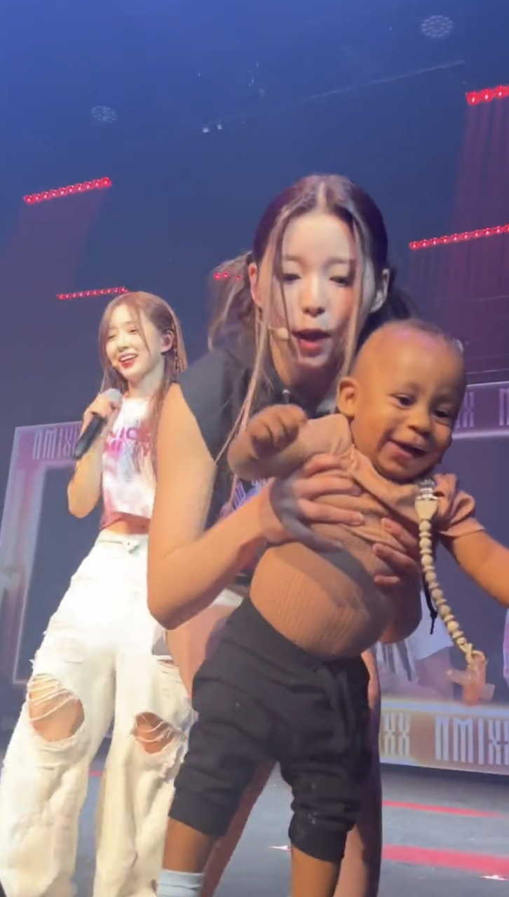 See shocking moment baby crawls on stage from crowd while K-pop group NMIXX were performing (video)