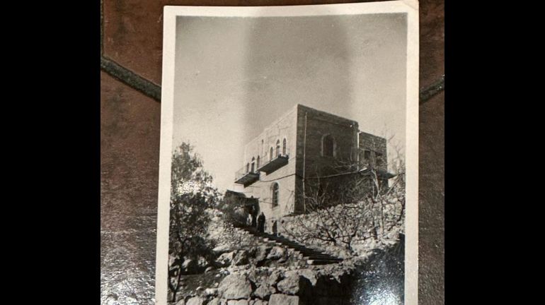 A black and white photo of Leila's childhood home