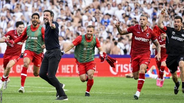 Royal Antwerp coach Mark van Bommel celebrates with his players after Toby Alderweireld scores in stoppage time to win the Belgian league title
