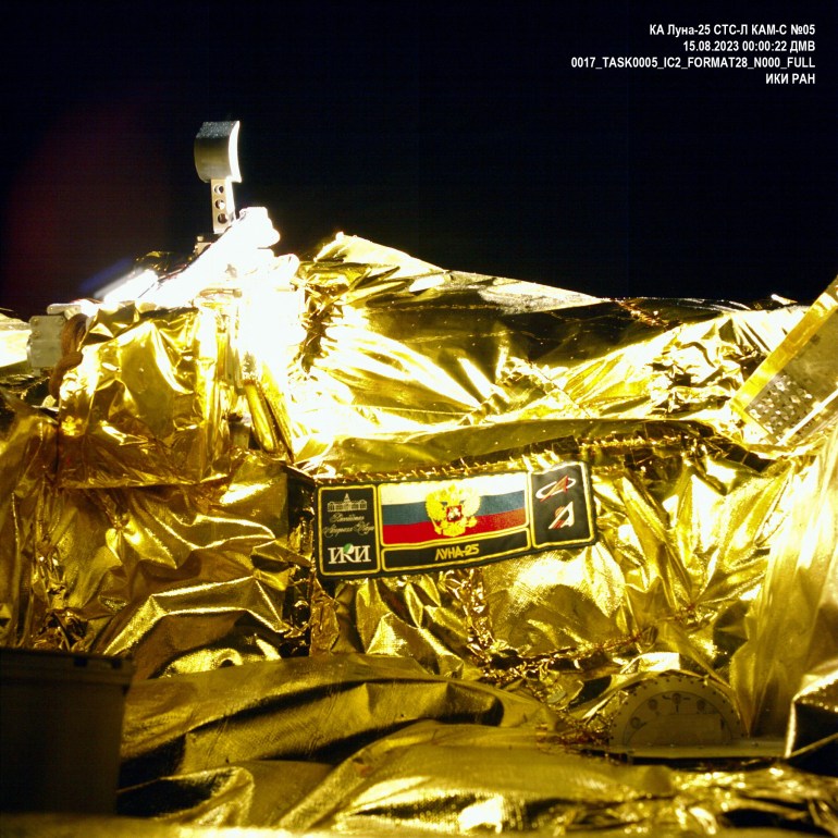A picture taken from the camera of the lunar landing spacecraft Luna-25 during its flight to the moon shows the mission emblem and the bucket of the lunar manipulator complex, August 15, 2023. Roscosmos/Handout via REUTERS ATTENTION EDITORS - THIS IMAGE HAS BEEN SUPPLIED BY A THIRD PARTY. MANDATORY CREDIT.