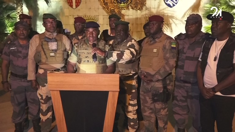 This video grab taken from Gabon 24 shows Gabonese soldiers appearing on television on August 30, 2023 announcing they were "putting an end to the current regime" and the cancellation of an election that, according to official results, President Ali Bongo Ondimba won. - During the announcement, AFP journalists heard gunfire ring out in the Gabonese capital, Libreville. While announcing the cancellation of the results one of the soldiers announced the dissolution of "all the institutions of the republic". "We have decided to defend peace by putting an end to the current regime", one of the soldiers said on TV channel Gabon 24, adding that he was speaking on behalf of the "Committee for the Transition and Restoration of Institutions". "To this end, the general elections of 26 August 2023 and the truncated results are cancelled," he added. "All the institutions of the republic are dissolved: the government, the Senate, the National Assembly and the Constitutional Court," he added, announcing the closure of the country's borders "until further notice". Among the soldiers were members of the Republican Guard as well as soldiers of the regular army and police officers. (Photo by - / Gabon 24 / AFP) / RESTRICTED TO EDITORIAL USE - MANDATORY CREDIT "AFP PHOTO / GABON 24" - NO MARKETING NO ADVERTISING CAMPAIGNS - DISTRIBUTED AS A SERVICE TO CLIENTS - RESTRICTED TO EDITORIAL USE - MANDATORY CREDIT "AFP PHOTO / GABON 24" - NO MARKETING NO ADVERTISING CAMPAIGNS - DISTRIBUTED AS A SERVICE TO CLIENTS /
