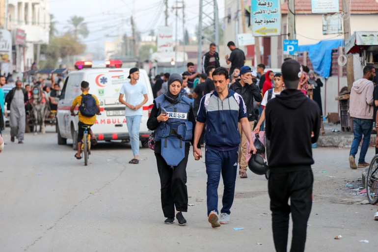 Khawla and her husband Baher walk back after she finishes work