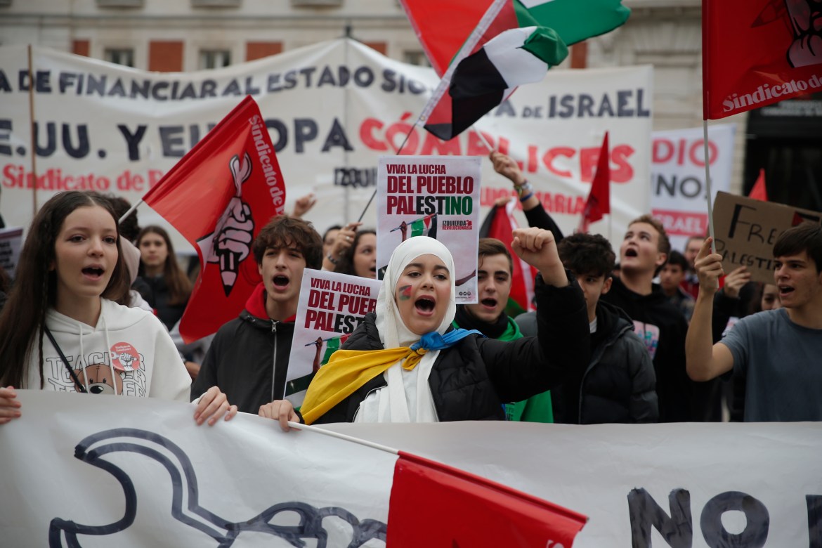 Students, holdings placards and flags, gather to stage protest in support of Palestinians in Madrid, Spain.